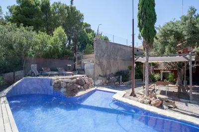 a swimming pool in a yard with a house at Ca Carmela casa con Encanto con Piscina 