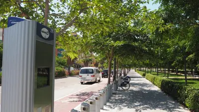 a white van driving down a street next to trees at Casa de Maria in Valencia