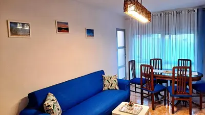 a living room with a blue couch and a table at Casa de Maria in Valencia