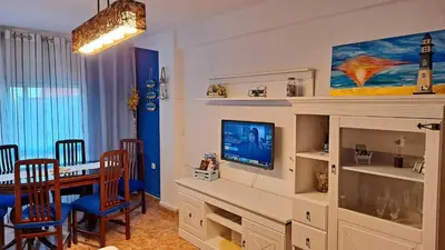 a living room with a dining table and a television at Casa de Maria in Valencia