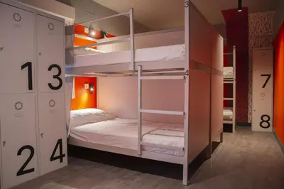 a room with a bunk bed with white bunk beds at room00 Valencia Hostel in Valencia