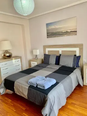 a bedroom with a large bed with two towels on it at Apartamento Playa el Cabanyal in Valencia
