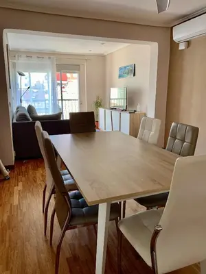 a dining room with a table and chairs at Apartamento Playa el Cabanyal in Valencia