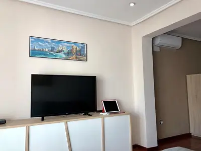 a flat screen tv sitting on top of a cabinet at Apartamento Playa el Cabanyal in Valencia