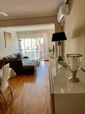 a kitchen and living room with a couch and a table at Apartamento Playa el Cabanyal in Valencia