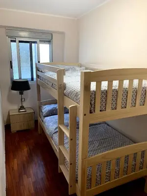 two bunk beds in a room with a lamp at Apartamento Playa el Cabanyal in Valencia