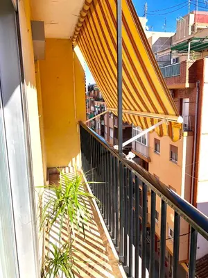 a balcony with a yellow awning on a building at Apartamento Playa el Cabanyal in Valencia