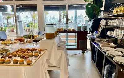 a bakery with pastries on tables in a kitchen at Hotel Playa Canet in Canet de Berenguer