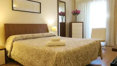 a bedroom with a bed with a yellow towel on it at Hotel Playa Canet in Canet de Berenguer