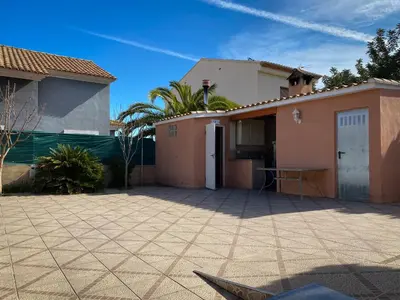 a house with a large patio in front of it at La perla de oasis in Lliria