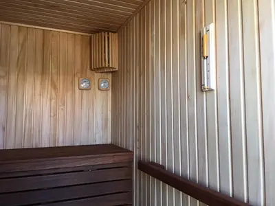 a room with a wooden paneled wall with two clocks at La perla de oasis in Lliria