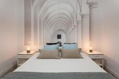 a bedroom with a large white bed with two night stands at TTdSSa VLC Purísima Street in Valencia