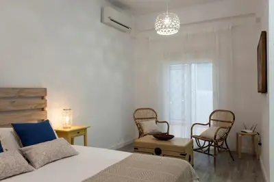 a bedroom with a bed and two chairs and a window at TTdSSa VLC Purísima Street in Valencia