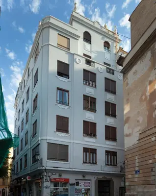 a white building with windows on a city street at TTdSSa VLC Purísima Street in Valencia