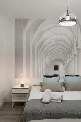 a bedroom with a large bed with a ceiling at TTdSSa VLC Purísima Street in Valencia