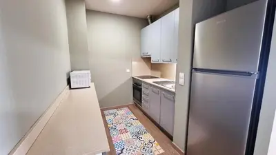 a small kitchen with a stainless steel refrigerator at Residencia Universitaria Resa Damia Bonet in Valencia