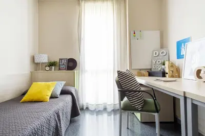 a bedroom with a bed and a desk and a chair at Residencia Universitaria Resa Damia Bonet in Valencia