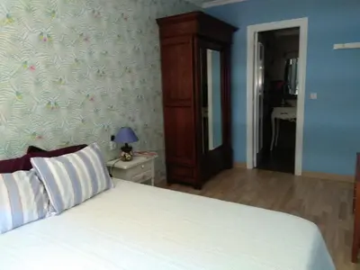 a bedroom with a white bed with a dresser and a mirror at Apartamento in Valencia