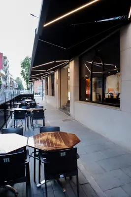 a row of tables and chairs outside of a restaurant at Hotel Benetusser in Benetúser
