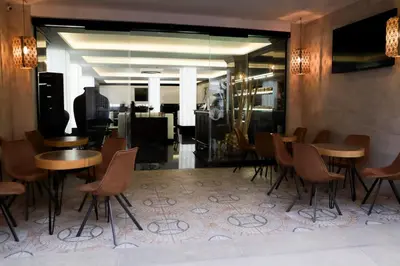 a restaurant with wooden tables and chairs in a room at Hotel Benetusser in Benetúser