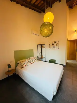 a bedroom with a large white bed and a chandelier at Casa Sibarita in Rafelguaraf