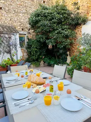 a table with plates and glasses of orange juice at Casa Sibarita in Rafelguaraf