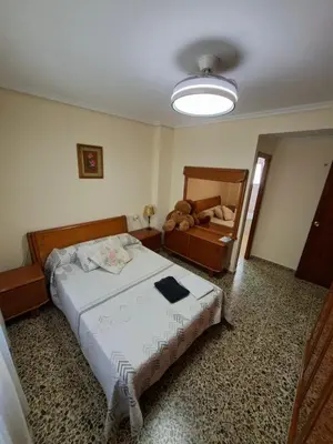 a small bedroom with a bed and a mirror at APARTAMENTO BEATRIZ 2 in Burriana