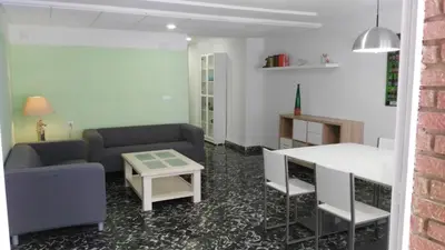 a living room with two couches and a table at Cullera Beach by Zagal Apartments in Cullera