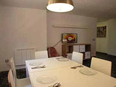 a dining room with a white table and chairs at Cullera Beach by Zagal Apartments in Cullera