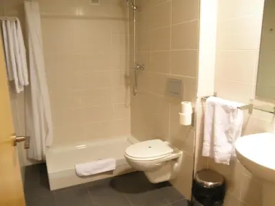 a bathroom with a toilet and a shower and a sink at Dormavalencia Hostel in Valencia