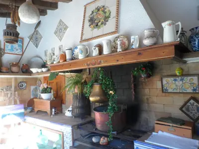 a room with a shelf filled with ceramics at Casa con jardín frente Playa de Burriana in Burriana