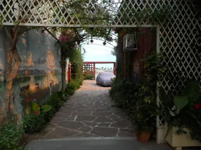 a garden with an archway with plants and a fence at Casa con jardín frente Playa de Burriana in Burriana