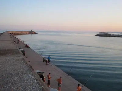 a group of people fishing in the water at Casa con jardín frente Playa de Burriana in Burriana