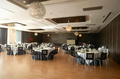 a banquet hall with tables and chairs and chandeliers at AZZ Valencia Congress Hotel & Spa in Paterna