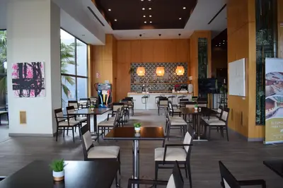 a restaurant with tables and chairs and a bar at AZZ Valencia Congress Hotel & Spa in Paterna