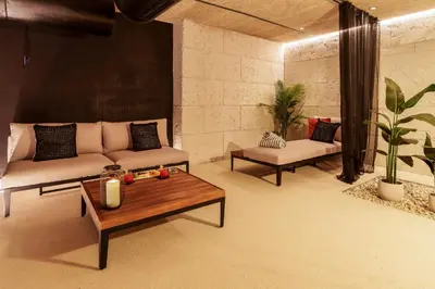 a living room with a couch and a coffee table at AZZ Valencia Congress Hotel & Spa in Paterna