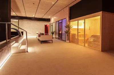 a lobby with a staircase and a living room at AZZ Valencia Congress Hotel & Spa in Paterna