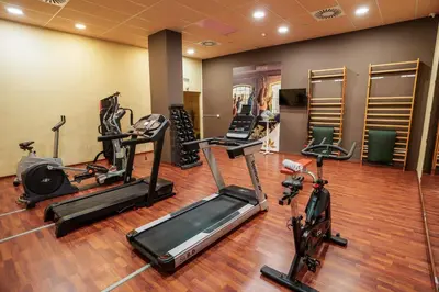 a gym with several exercise bikes and treadmills at AZZ Valencia Congress Hotel & Spa in Paterna