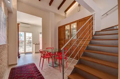 a dining room with a glass table and red chairs at Beds & Breaks Verdi 2 in Valencia