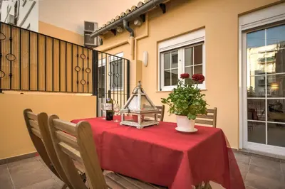 a table with a red table cloth and flowers on it at Beds & Breaks Verdi 2 in Valencia