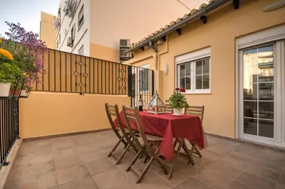 a table with a red table cloth on a patio at Beds & Breaks Verdi 2 in Valencia