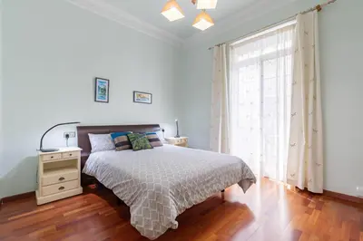a white bedroom with a bed and a window at Ruzafa Luis Santangel in Valencia