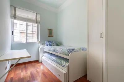 a small bedroom with a bed and a window at Ruzafa Luis Santangel in Valencia