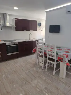 a kitchen with a table and chairs and a kitchen with a stove at Altura in Valencia
