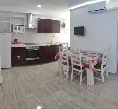 a kitchen with a table and chairs in a room at Altura in Valencia