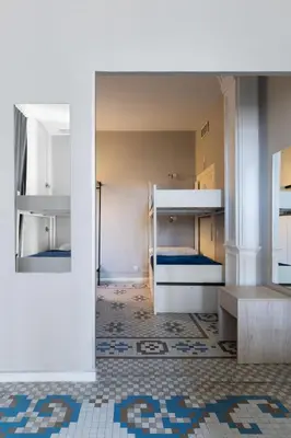 a room with bunk beds and a tile floor at Purple Nest Hostel in Valencia