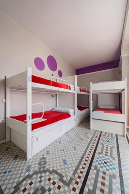 two bunk beds in a room with red and white at Purple Nest Hostel in Valencia