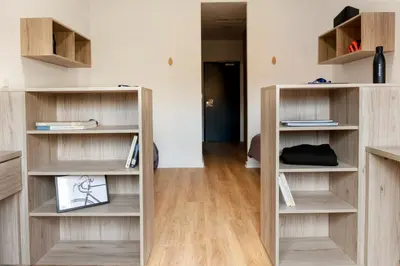 a room with wooden shelves and a hallway at Albergue Juvenil Colegio Mayor Galileo Galilei in Valencia