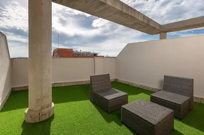two chairs on a balcony with green grass at Albergue Juvenil Colegio Mayor Galileo Galilei in Valencia