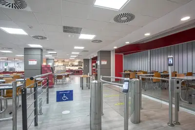 an empty cafeteria with tables and chairs in a building at Albergue Juvenil Colegio Mayor Galileo Galilei in Valencia